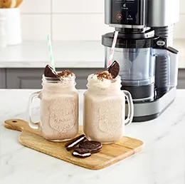 A small white Pandora Tabletop Mirror with a gold frame on a beige background